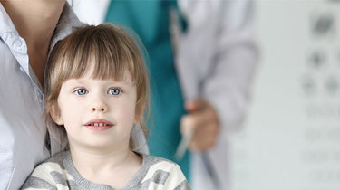 Et barn sidder hos en af Aleris børnelæger, der tjekker barnets heldbred og udvikling.